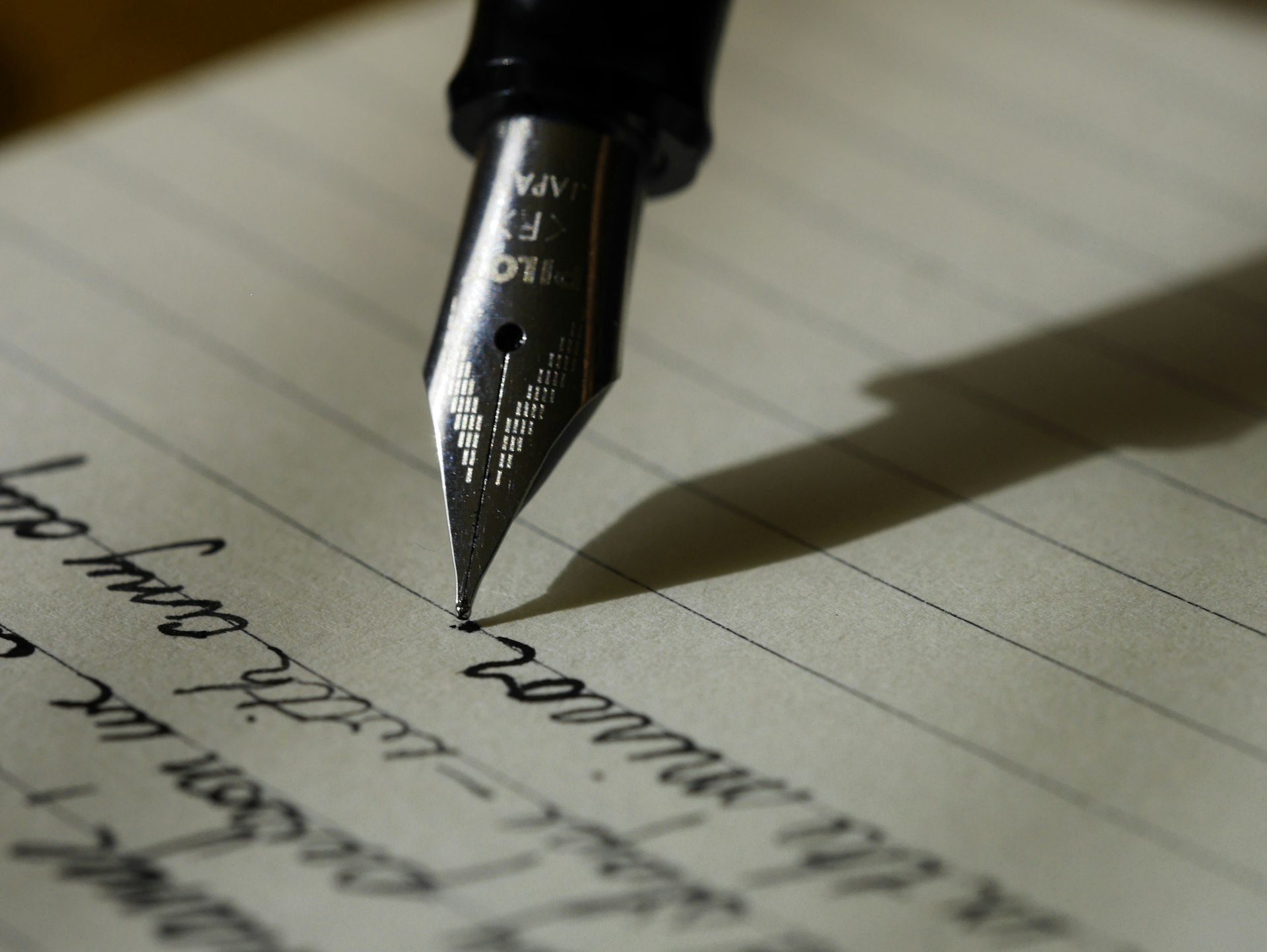 A fountain pen writing in a journal
