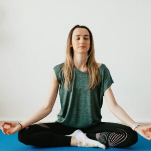 Woman meditating peacefully on a yoga mat